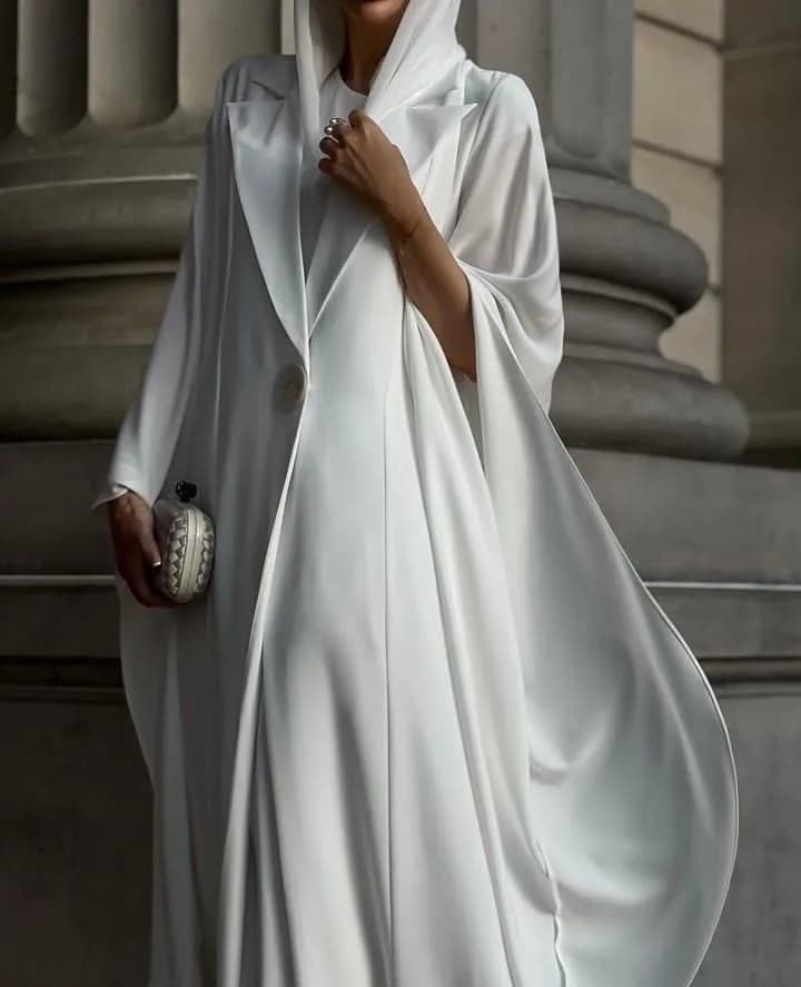 Woman wearing a white draped outfit